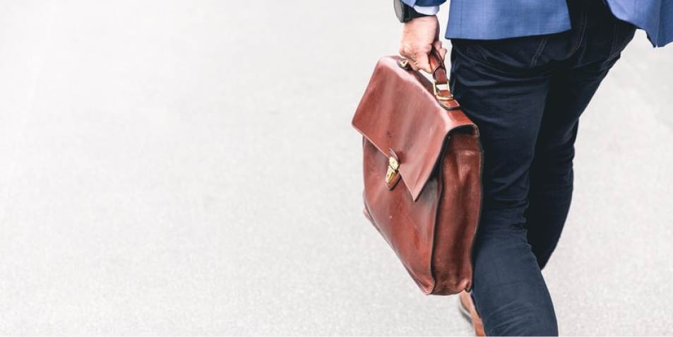 Man carrying brown briefcase